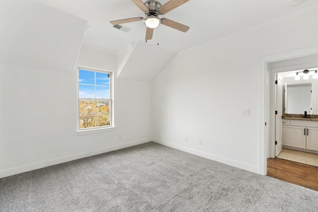 bonus room with ceiling fan, light colored carpet, lofted ceiling, and sink