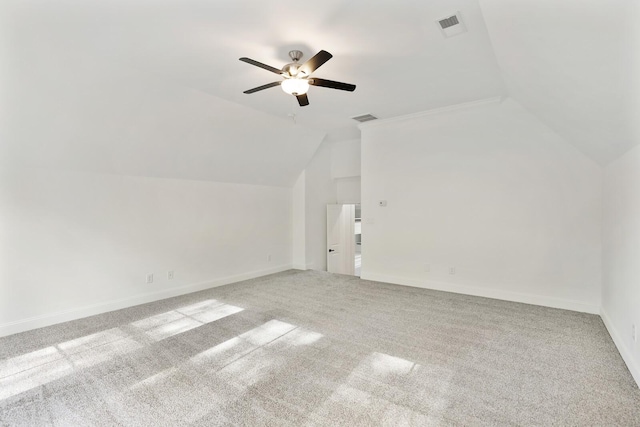 additional living space with light carpet, vaulted ceiling, and ceiling fan