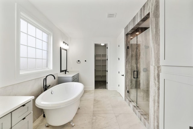 bathroom with vanity and shower with separate bathtub