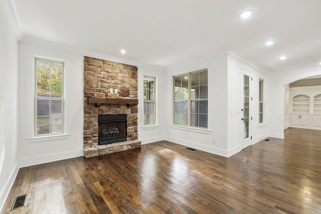 unfurnished living room with crown molding, a fireplace, and dark hardwood / wood-style floors