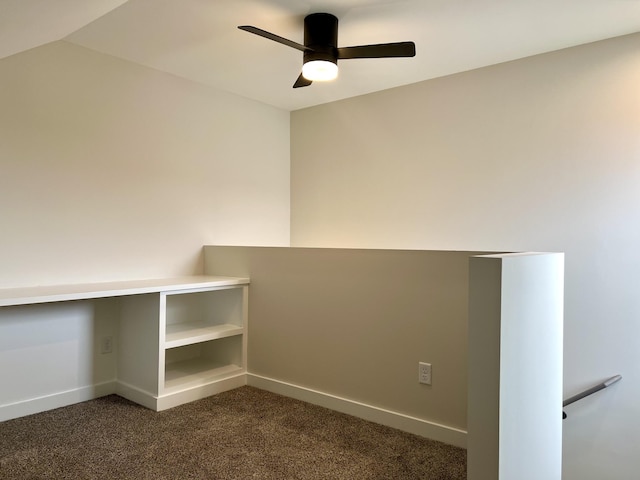 interior space featuring dark carpet and ceiling fan