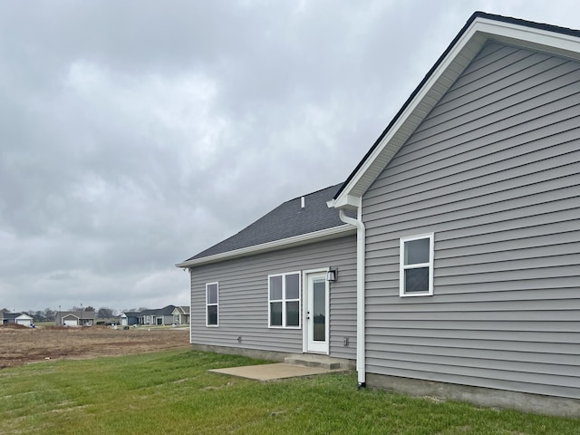 back of property featuring a yard