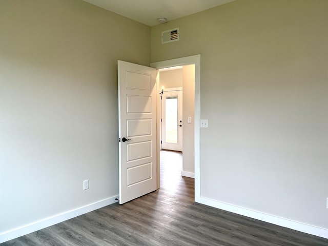 empty room featuring dark wood-type flooring