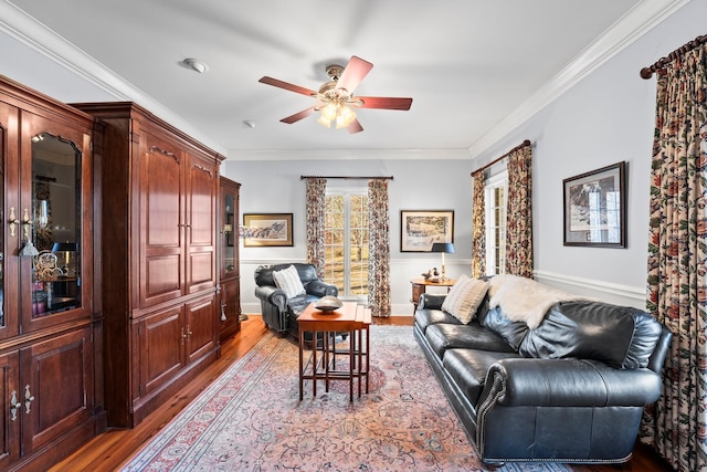 living room with hardwood / wood-style floors, ceiling fan, and crown molding