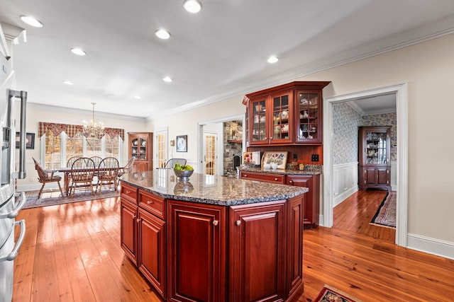 255 Parks Dr, Normandy, TN 37360 - kitchen featuring dark brown cabinets, light wood-type flooring, a chandelier, crown molding, and hanging light fixtures