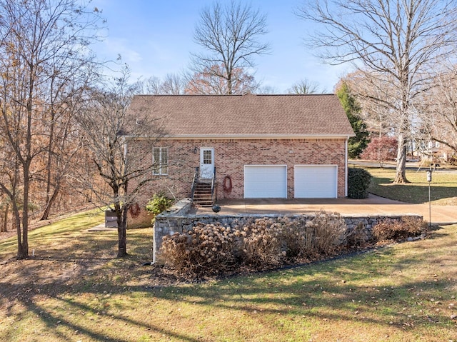 255 Parks Dr, Normandy, TN 37360 - view of front of home with brick siding, a shingled roof, a front lawn, driveway, and an attached garage