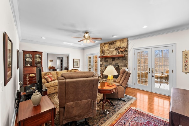 living room featuring ceiling fan, french doors, wood-type flooring, and ornamental molding