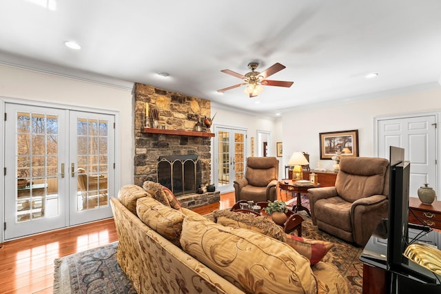 living room with french doors, ceiling fan, crown molding, and wood-type flooring