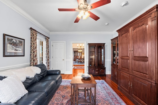 living room with ceiling fan, dark hardwood / wood-style flooring, and crown molding