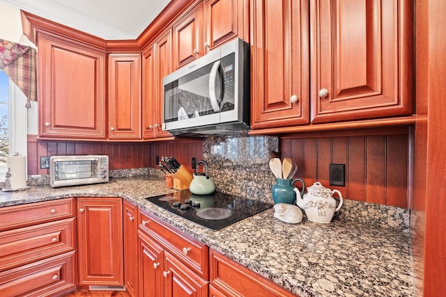 255 Parks Dr, Normandy, TN 37360 - kitchen featuring stainless steel microwave, black electric cooktop, backsplash, and light stone countertops