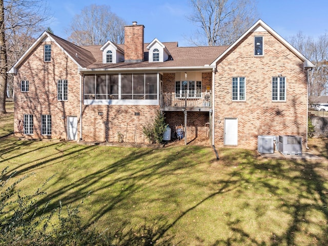 255 Parks Dr, Normandy, TN 37360 - back of house featuring a sunroom, a chimney, brick siding, and a lawn