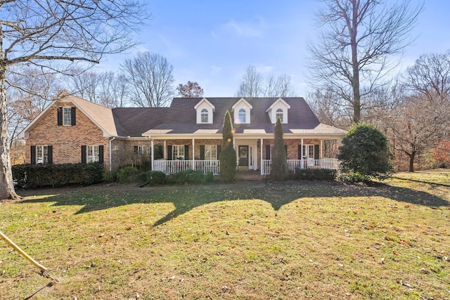 255 Parks Dr, Normandy, TN 37360 - cape cod house featuring brick siding, a porch, and a front lawn