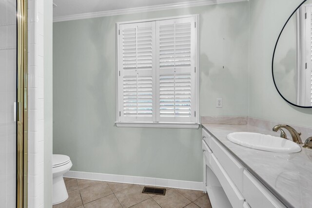 bathroom featuring vanity, crown molding, tile patterned flooring, toilet, and an enclosed shower