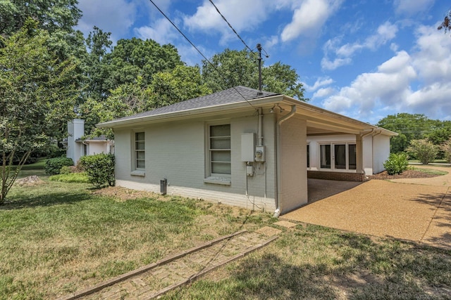 rear view of property featuring a yard and a patio