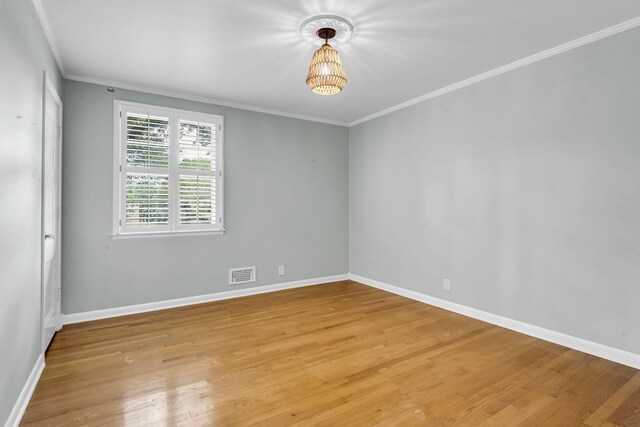 empty room with light hardwood / wood-style floors and ornamental molding