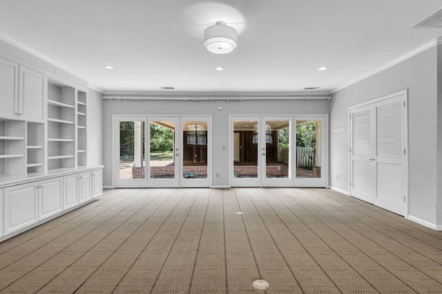 unfurnished living room with crown molding and french doors