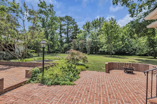 view of patio / terrace featuring an outdoor fire pit