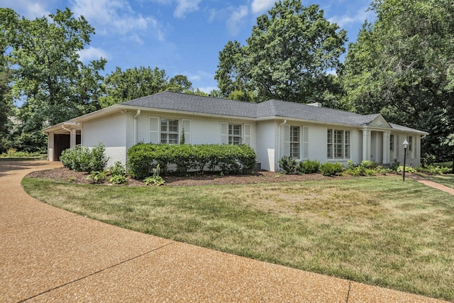 single story home featuring a front yard and a garage