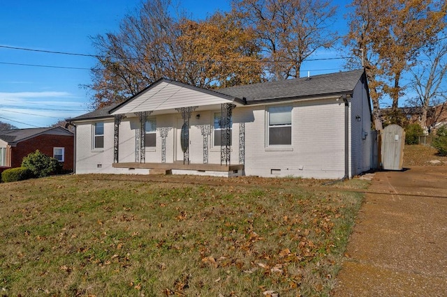 view of front facade with a front yard and covered porch