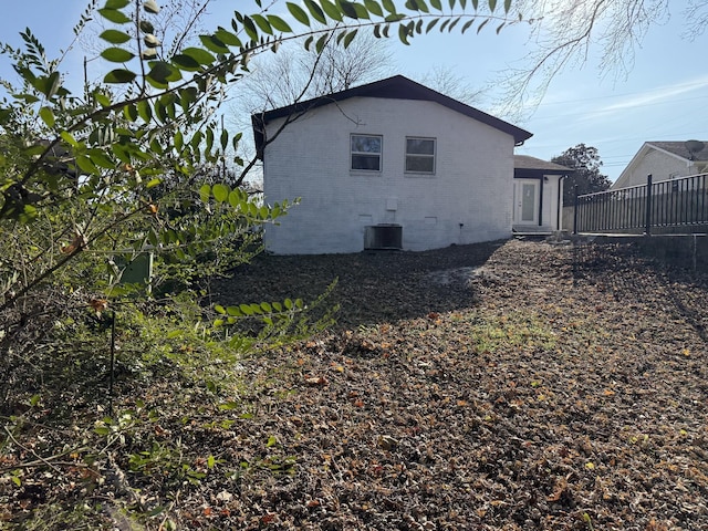 rear view of house featuring cooling unit