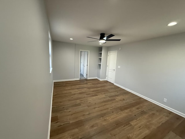 spare room featuring dark hardwood / wood-style floors and ceiling fan