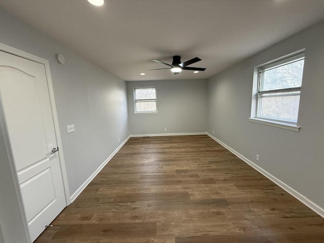 empty room featuring ceiling fan and dark hardwood / wood-style floors