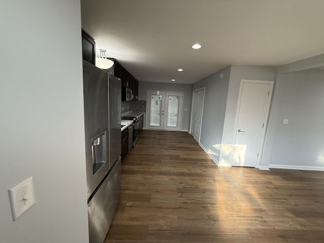 kitchen featuring backsplash, dark hardwood / wood-style floors, stainless steel appliances, and french doors