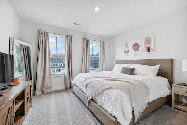 bedroom with light colored carpet