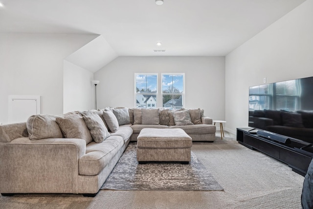 carpeted living room with lofted ceiling