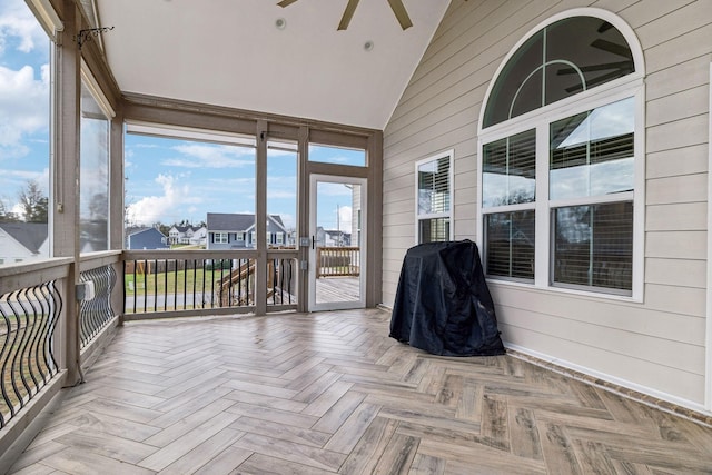 sunroom / solarium with ceiling fan and lofted ceiling