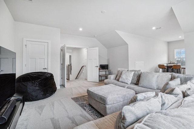 carpeted living room with lofted ceiling