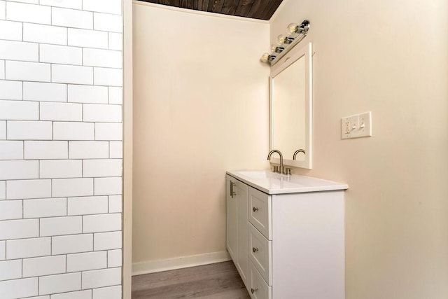 bathroom featuring wood-type flooring, vanity, and wooden ceiling