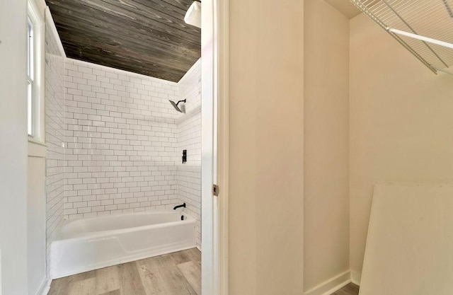 bathroom with tiled shower / bath combo and wood-type flooring