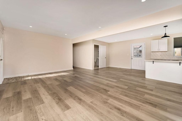 unfurnished living room with light hardwood / wood-style flooring