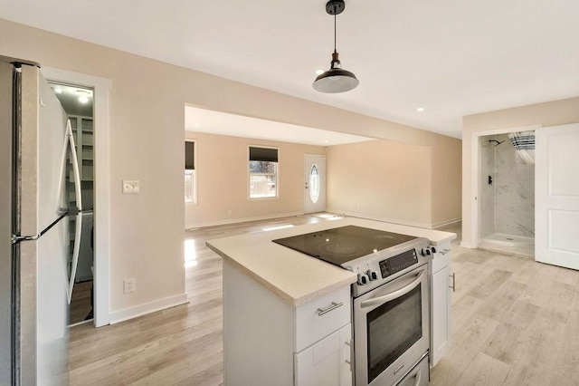 kitchen featuring white cabinetry, stainless steel appliances, and light wood-type flooring