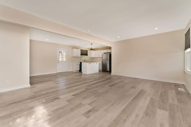 unfurnished living room with light hardwood / wood-style floors