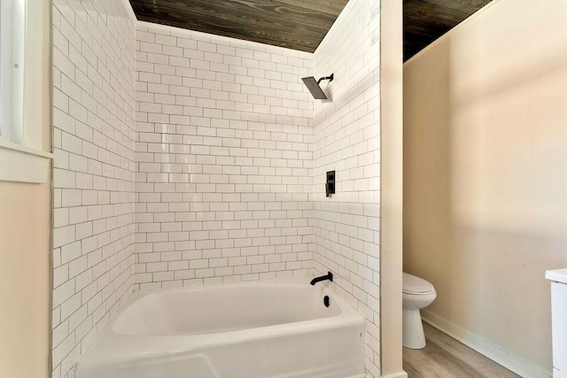 bathroom featuring hardwood / wood-style flooring, toilet, tiled shower / bath, and wood ceiling