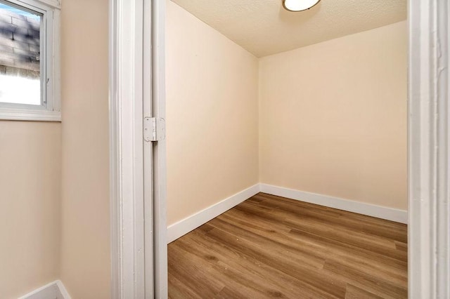 interior space featuring a textured ceiling and hardwood / wood-style flooring