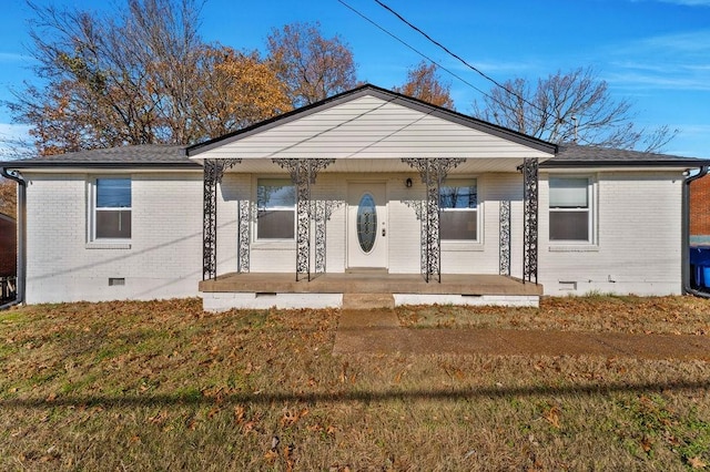 view of front of house with covered porch and a front yard