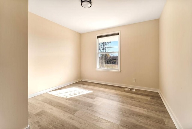 unfurnished room featuring wood-type flooring