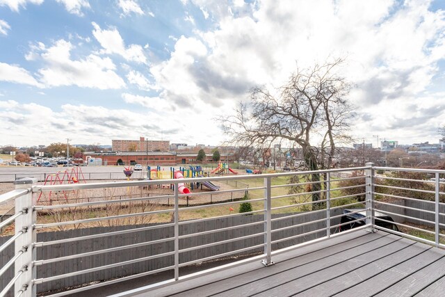 wooden deck featuring a playground