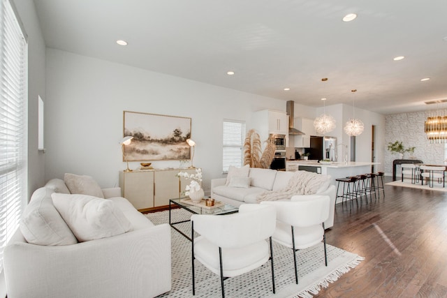 living room featuring dark hardwood / wood-style flooring and a chandelier