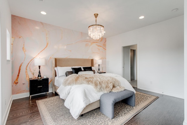 bedroom featuring a chandelier and dark hardwood / wood-style flooring