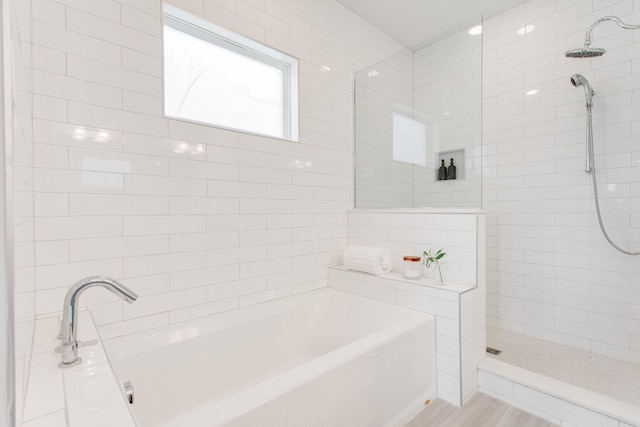 bathroom featuring wood-type flooring and plus walk in shower