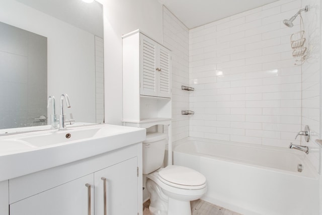 full bathroom with vanity, toilet, and tiled shower / bath