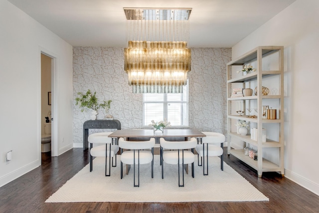 dining area with dark wood-type flooring and a notable chandelier