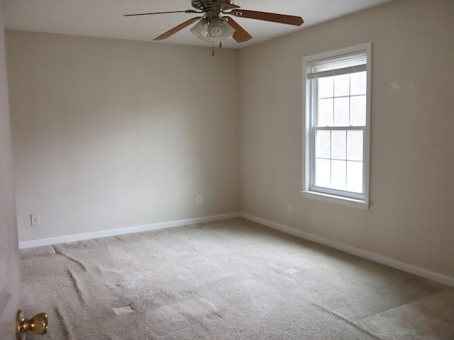 spare room with light carpet and ceiling fan