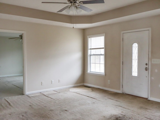 carpeted entryway with ceiling fan