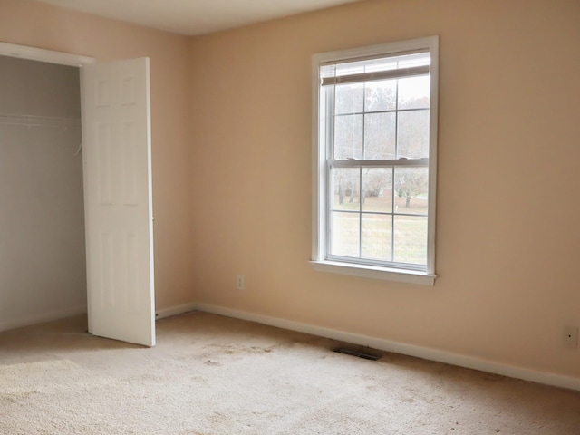 unfurnished bedroom with carpet floors and a closet