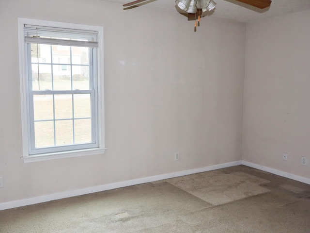 spare room with carpet flooring, plenty of natural light, and ceiling fan